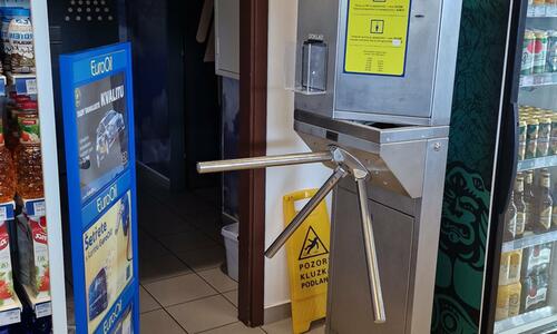 Turnstile with coin-operated turnstile at the entrance to the toilets at the petrol station