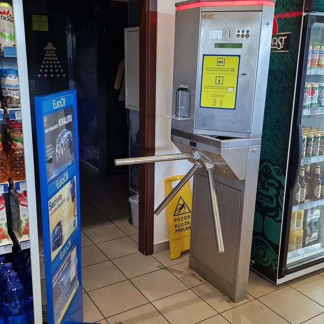 Turnstile with coin-operated turnstile at the entrance to the toilets at the petrol station